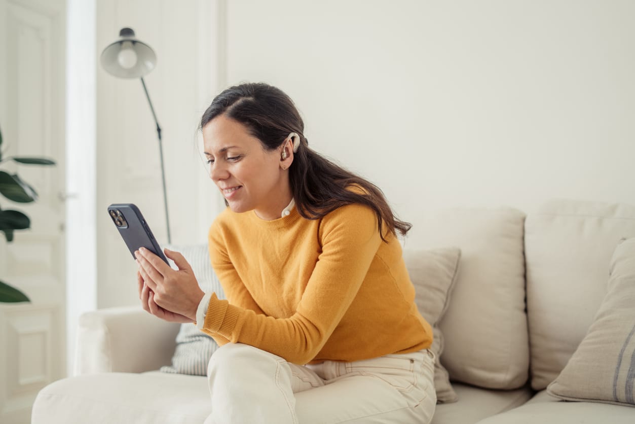 Woman listening to an audiobook through her hearing aids.